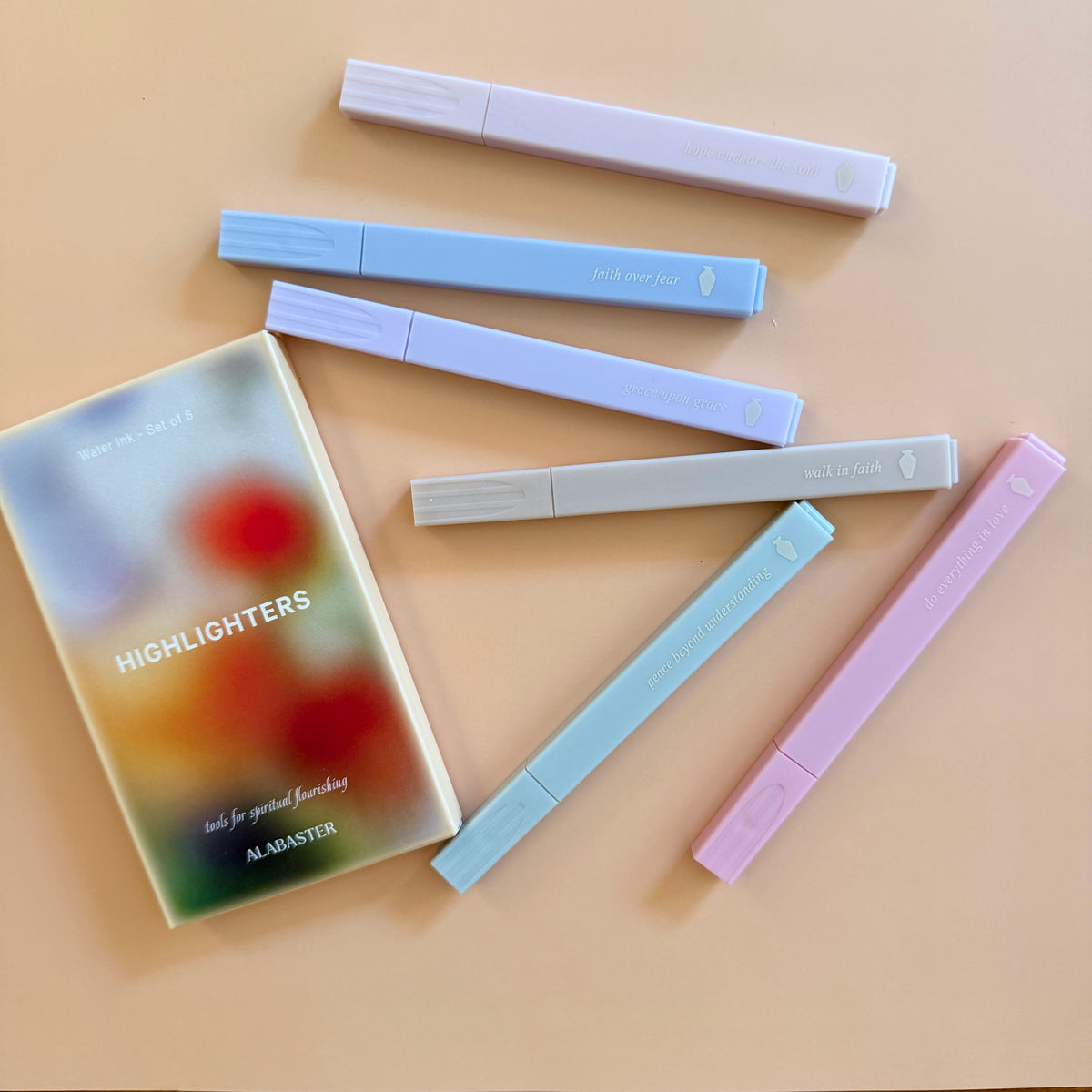 6 highlighters by Alabaster Co. laid out on a light beige background. 