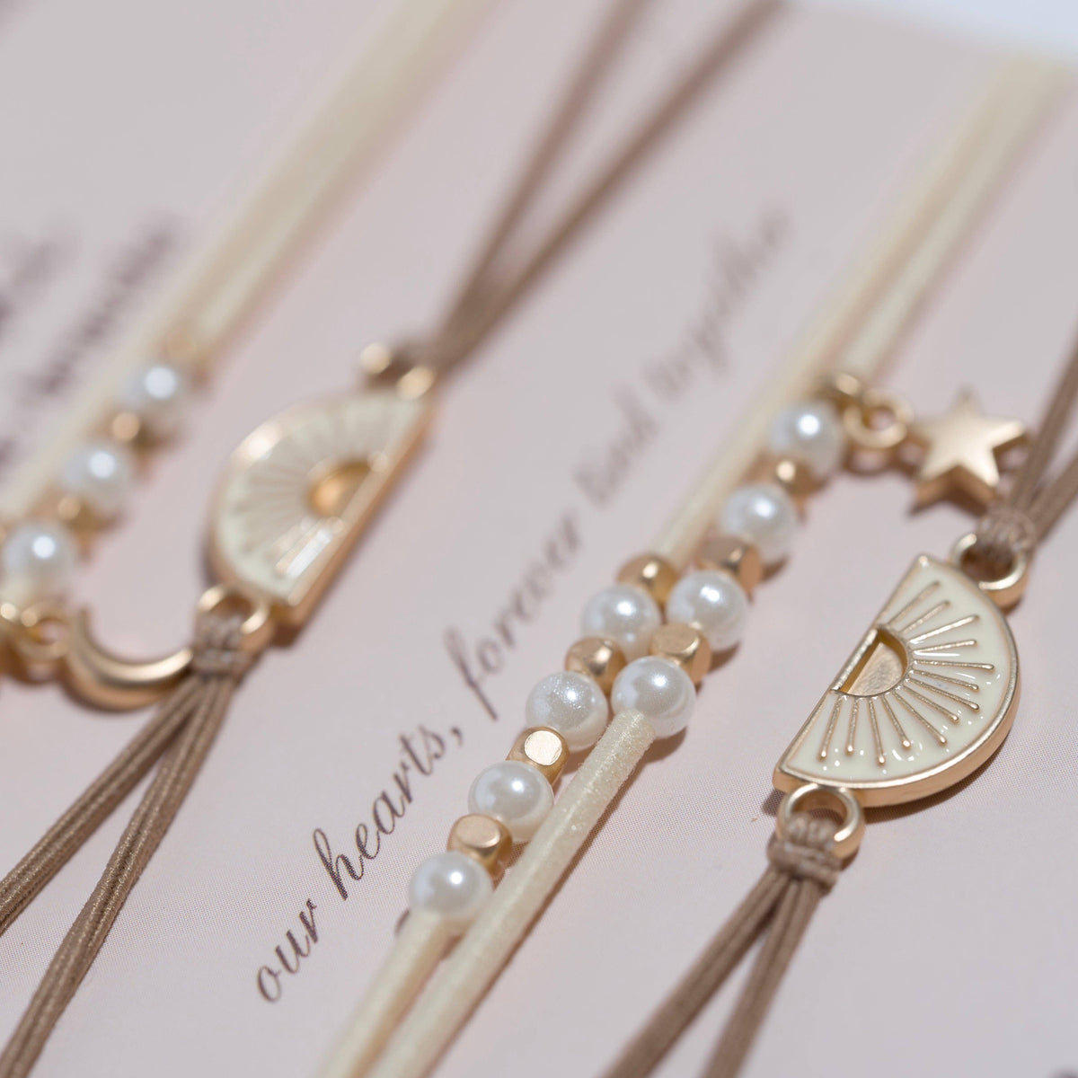 Gold and pearl hair accessories on a pink background with 'our hearts, forever' text.
