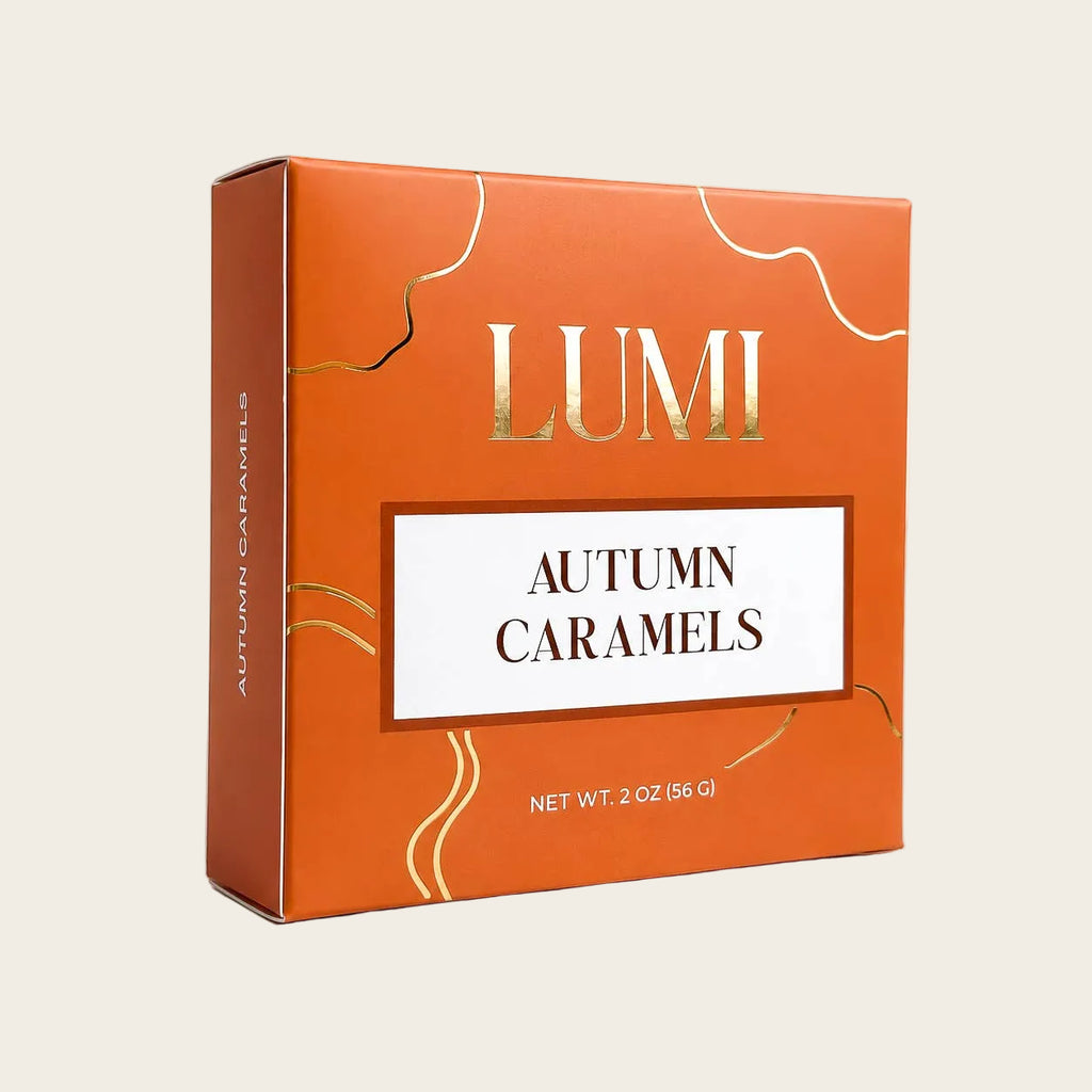 LUMI Autumn Caramels in a square orange box with gold decorative lines and a white label in the center.