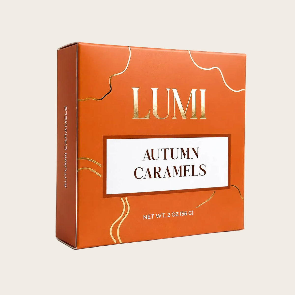 LUMI Autumn Caramels in a square orange box with gold decorative lines and a white label in the center.