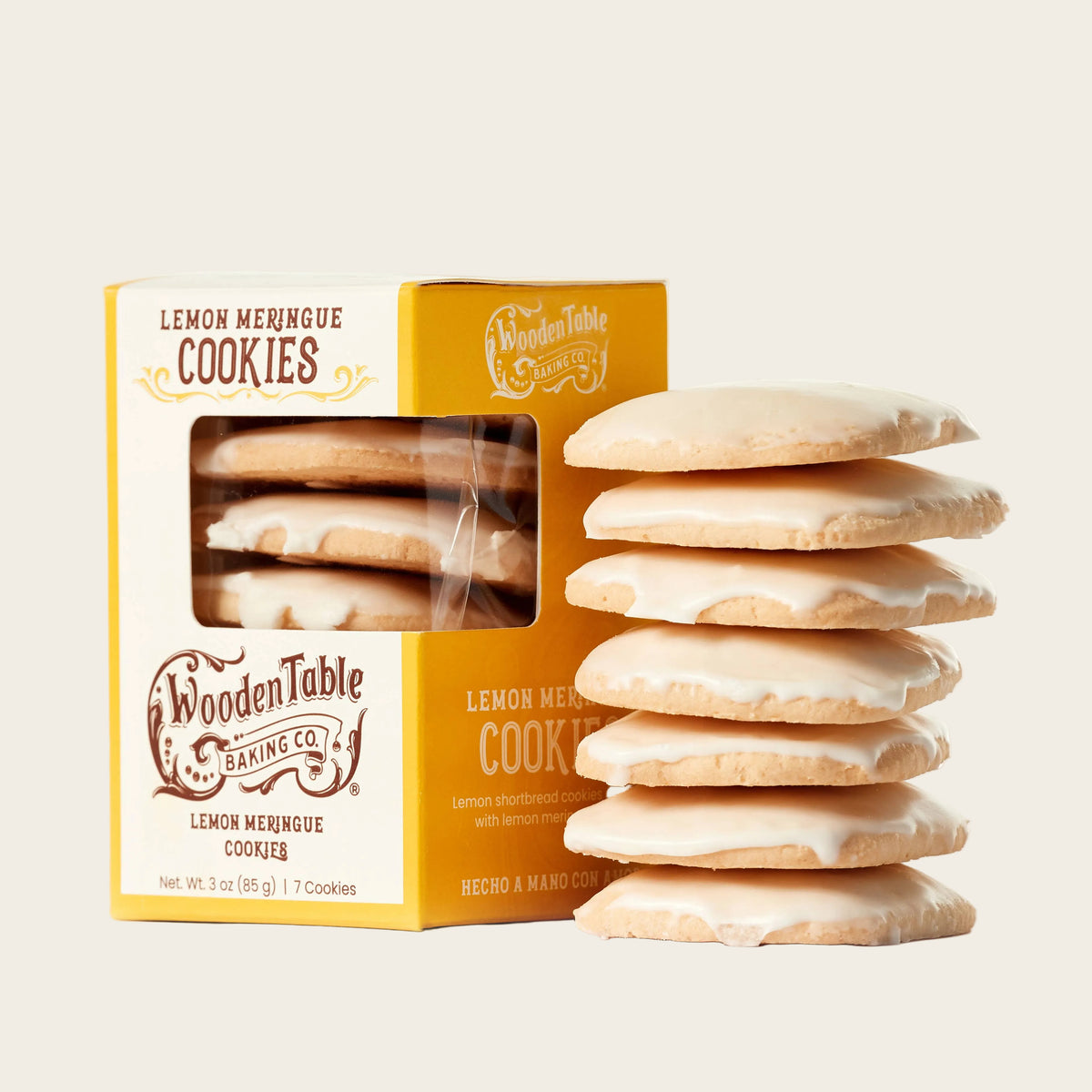 Stack of lemon meringue cookies next to a box from Wooden Table Baking Co.