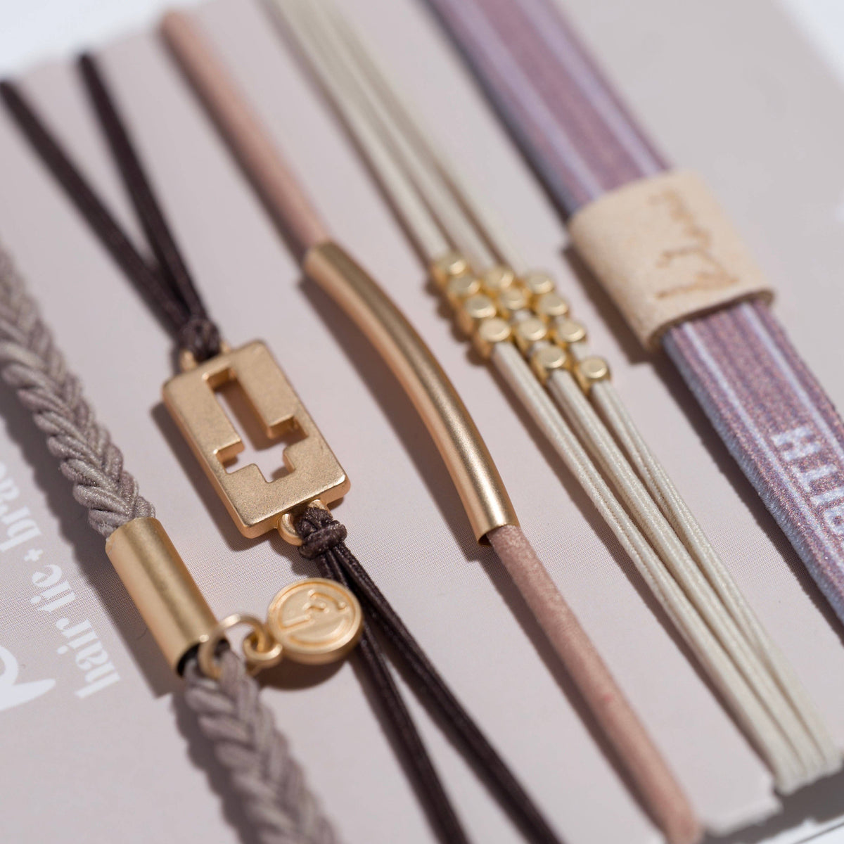 Set of hair ties with gold clasp on a neutral background